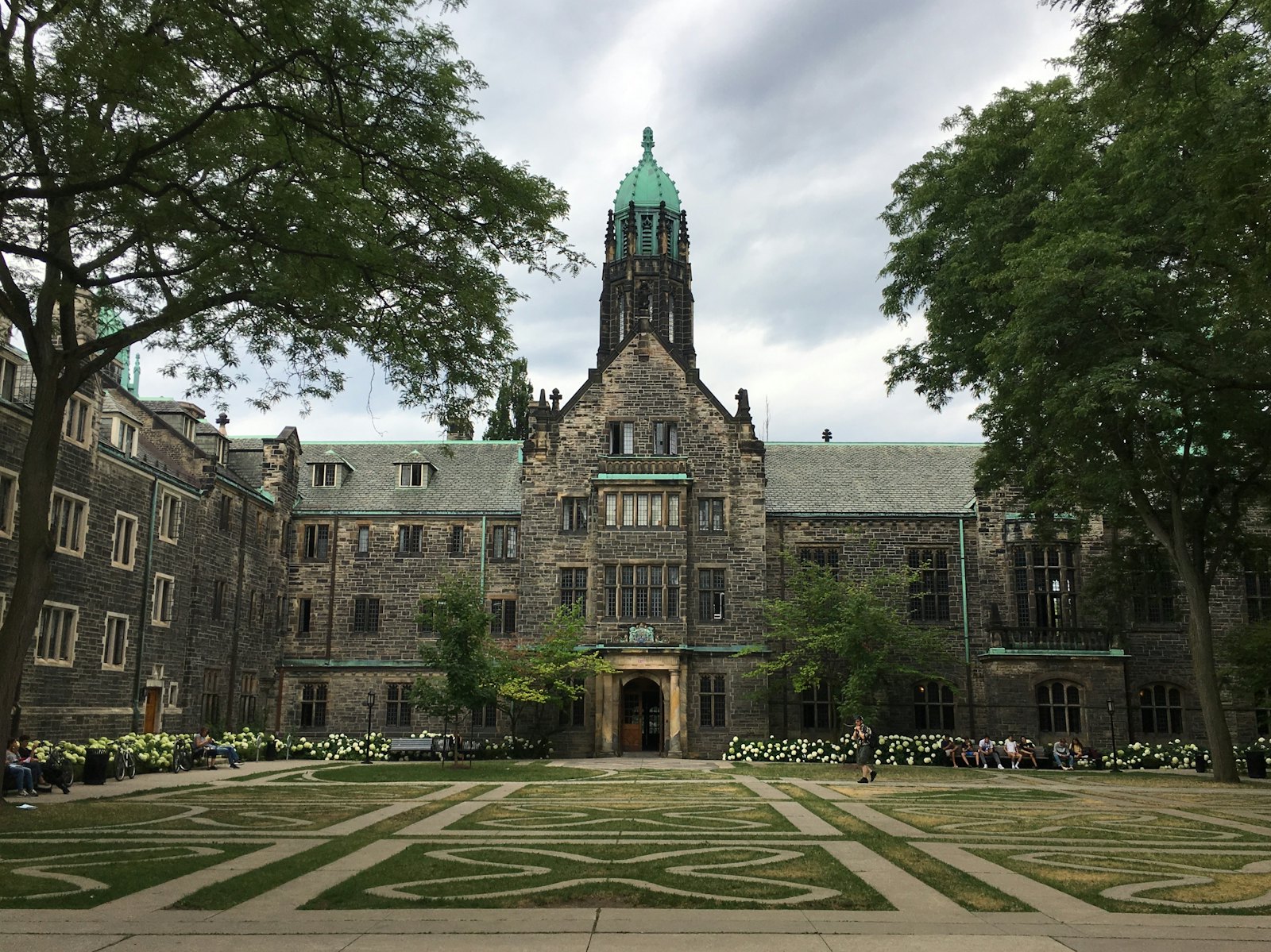 加拿大公立大学哥特式石砌建筑校园,绿草坪与古典塔楼,典型的加拿大东部大学风貌